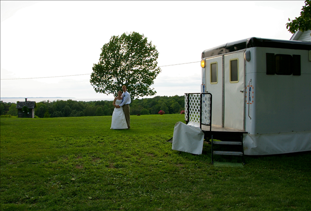 A man standing in front of a portable toilet.